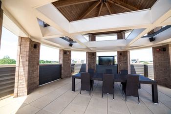 a large patio with a table and chairs at The Foundry, Indiana, 46617